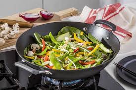Family cooking meals using Anolon Endurance+ 36cm wok in modern kitchen setting